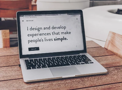 Laptop with the words I design and develop experiences that make people's lives simple